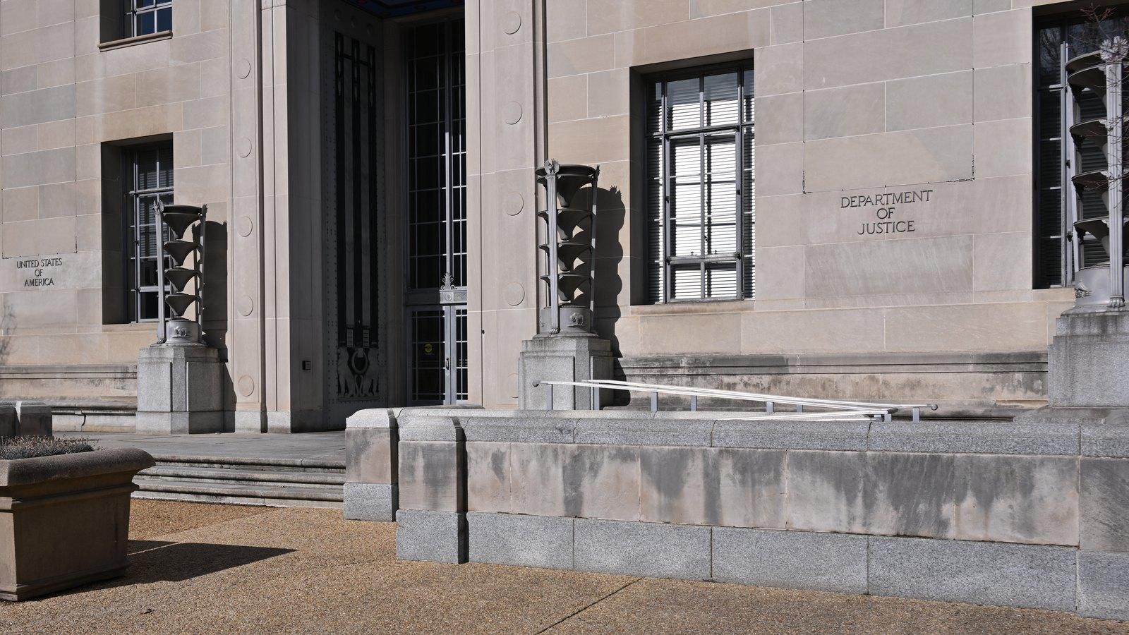 A stone entrance to the Robert F. Kennedy Department of Justice Building in Washington, with 'Department of Justice' carved into the wall